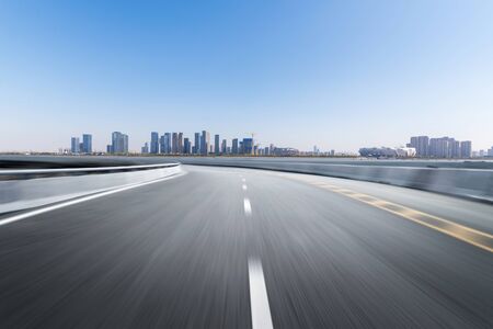 Empty road floor surface with modern city landmark buildings of hangzhou bund Skyline,zhejiang,chinaの写真素材