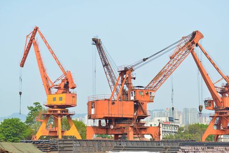 The crane is hoisting containers at the wharfの写真素材