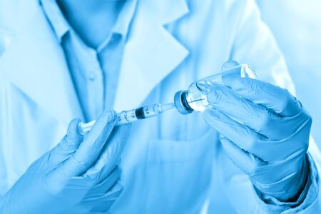 Laboratory beaker in analyst's hand in plastic gloveの写真素材