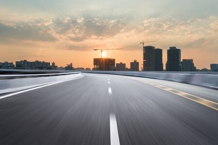 Motion-blurred highway in dusk cloudsの写真素材