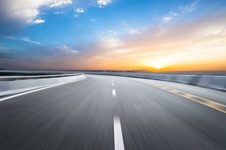 Motion-blurred highway in dusk cloudsの写真素材