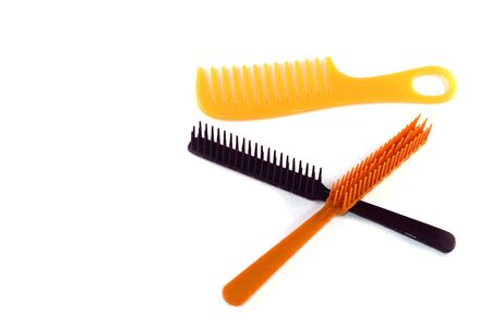 brown and orange hairbrush on white backgroundの写真素材