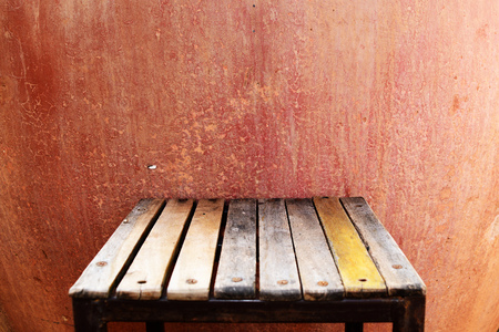 the wooden chair with color cement backgroundの写真素材