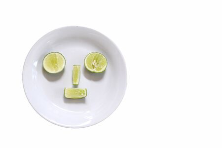 lemon face on dish with white backgroundの写真素材