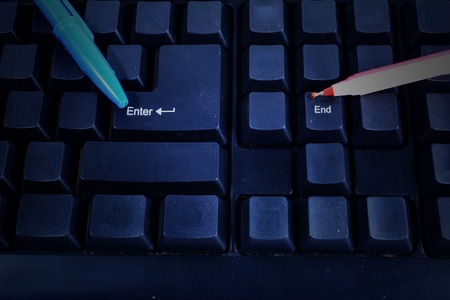 2 pens point to Enter and End on keyboardの写真素材