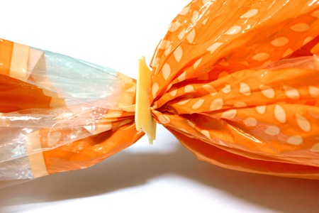 the lock pad locked on orange plastic bag of breadの写真素材