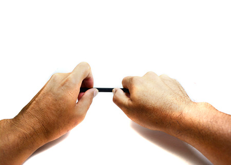 2 hand holding black pencil on white background isolatedの写真素材