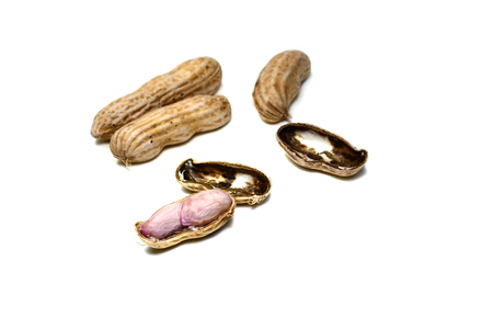 peeling raw peanuts on white background isolated