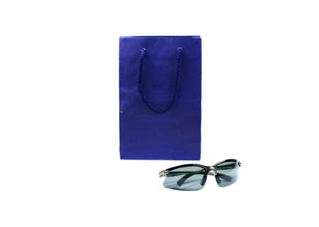 dark blue shopping bag  and  black  sport glasses on white background isolatedの写真素材