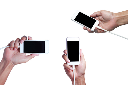 adult hand holding smart phone with electric  charger on white background isolatedの写真素材