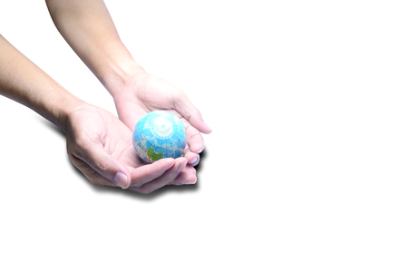 hands of adult man holding b;ue globe with bright light on white background isolatedの写真素材