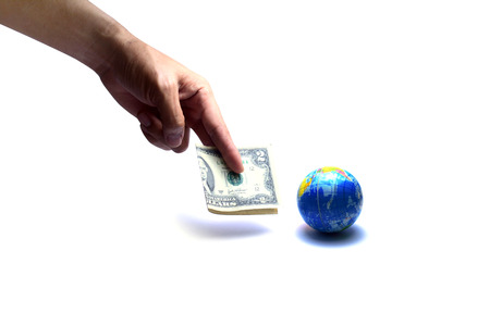 buy the world with some money .the hand showing two dollar note  near  the blue globe on white background isolatedの写真素材