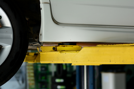 the yellow lift hand at the  lifting safety mark under the carの写真素材