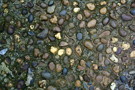 gravels and rocks on the deterioration of old cement ground from long time usedの写真素材