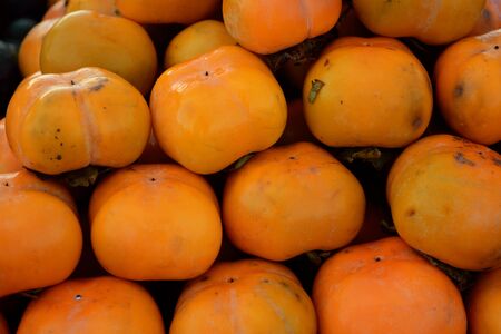 the Persimmon pile for sale at the fresh market in Thailandの写真素材