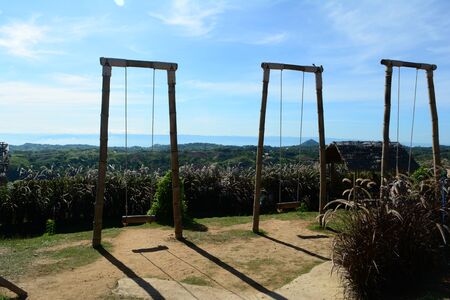 The bamboo swings  with grass flowers and blue sky at tourist attraction of northen Thailand