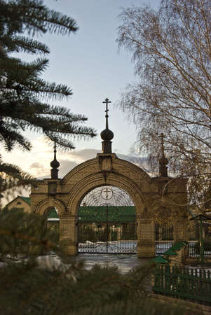 winter,snow,rain,trees, blue sky,cross,sunset,church,gatesの写真素材