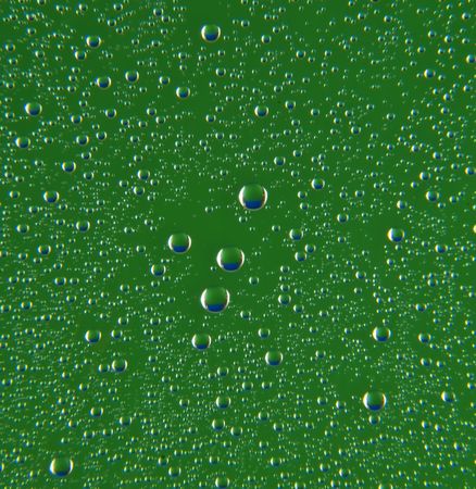 drops of water on a green backgroundの写真素材
