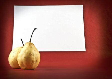 two ripe pears on a background  of white paperの写真素材