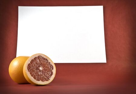 two ripe grapefruits on a background  of white paperの写真素材