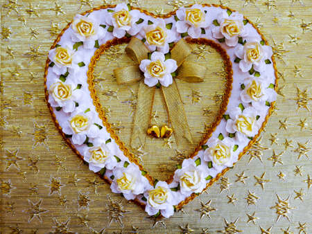 Kraft paper white rose shape heart on golden textureの写真素材