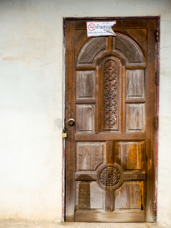 wooden old door put white sticker meaning "No Smoking"の写真素材