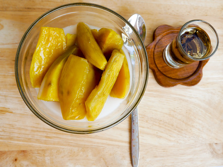 Sweet potato thai dessert with chinese tea on woodの写真素材
