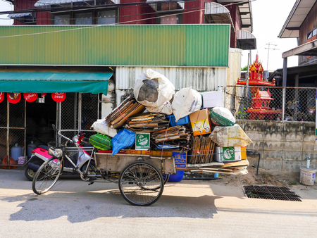 NAKHONRATCHASIMA ,THAILAND - FEBRUARY 3 : tricycle junk dealer ask to buy some junks and papers for recycle factory at Nakhonratchasima ,THAILANDの写真素材
