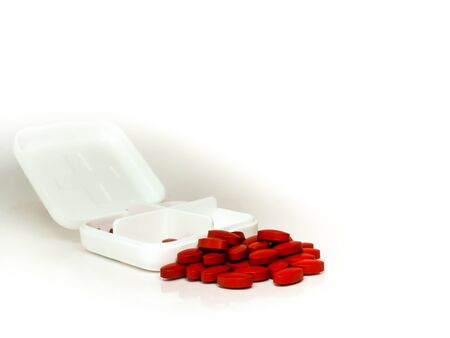 iron red pills in box isolated on white backgroundの写真素材