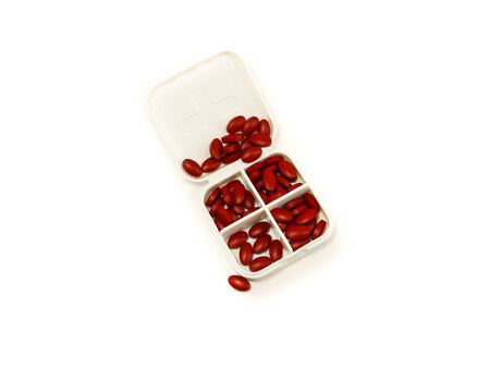 iron red pills in box isolated on white backgroundの写真素材