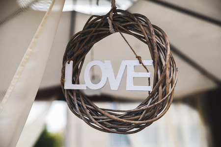 Love wooden text with the rope in the braided wreathの写真素材