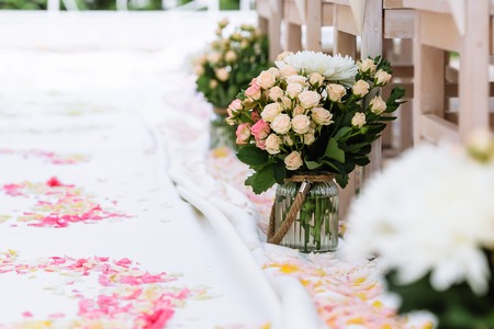 wedding ceremony decorations, rose petals, bouquet in vaseの写真素材