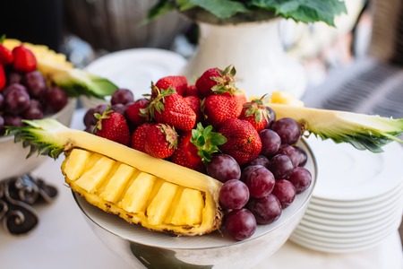 Wedding table fruit decoration at restaurant, pineapple, strawberry, grapeの写真素材