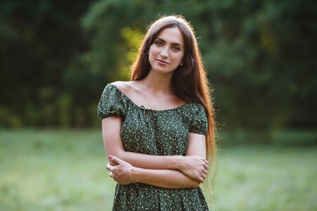 Young smiling woman portrait on grass backgroundの写真素材