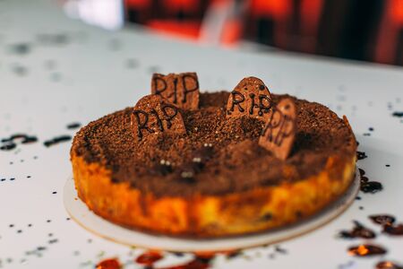 Cake with Festive Halloween graveyard Decoration on the tableの写真素材