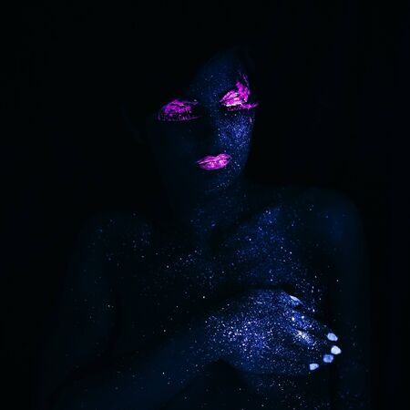 Portrait of Beautiful Fashion Woman in Neon UF Light. Model Girl with Fluorescent Creative...