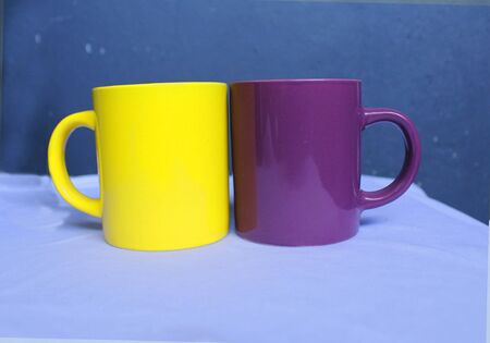 yellow and violet ceramics mugs for coupleの写真素材