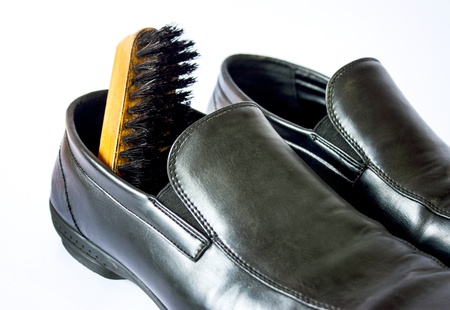 Business shoes with shoe polish brush on white backgroundの写真素材