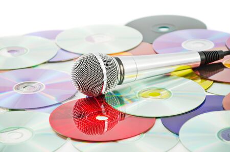 Microphone on the background of multicolored CDs