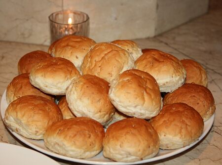 fresh warm bread with sesame seeds  Freshly baked bread set out on a plate