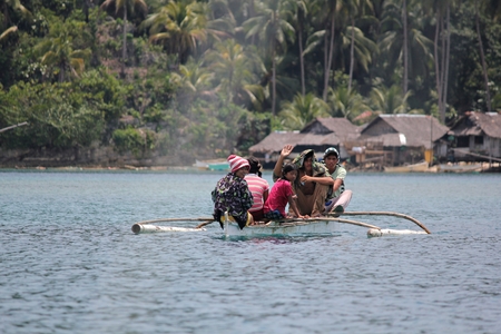 Boaters in Libtong Cove, Cantilan, Surigao del Sur-Editorial Passengers of a small boat approach the village of Libtong Cove in Cantilan, Surigao del Sur.のeditorial素材