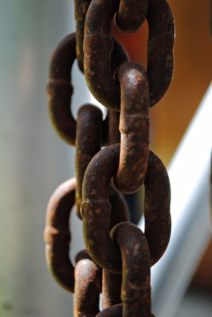 Close up of big sturdy rusty chains hanging