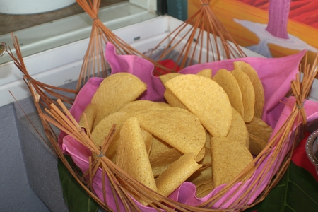 Crispy chips served in a wicker basket with pink clothの写真素材