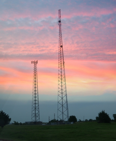 Electric power poles rising out at sunriseの写真素材
