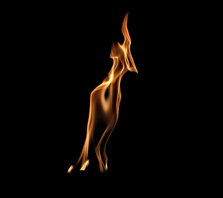 Artistic shapes from the flames of a burning torch leaning a bit to the right, with a dark backgroundの写真素材