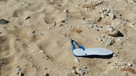 Broken slipper in the sandの写真素材