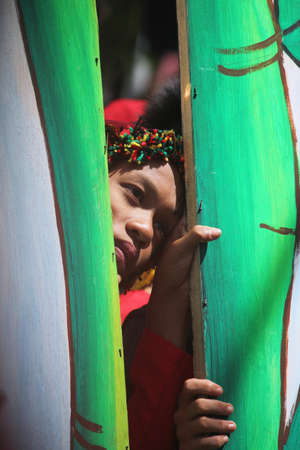 DAVAO CITY, PHILIPPINESâ€”AUGUST 2014: A participant peeks out through bamboo poles at the...