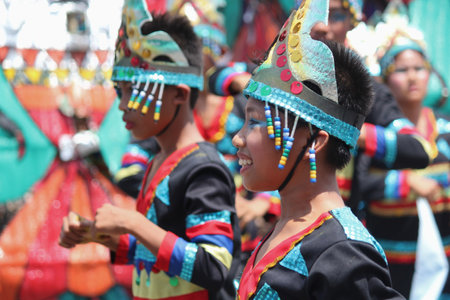DAVAO CITY, PHILIPPINESâ€”AUGUST 2014: Kids in colorful costumes at the Kadayawan street...