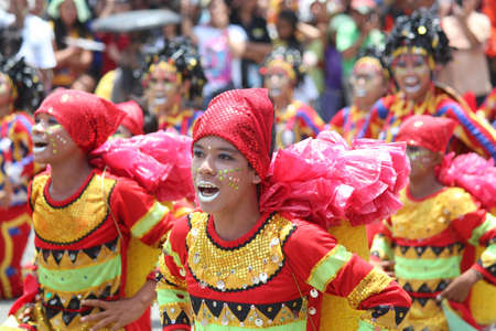 DAVAO CITY, PHILIPPINESâ€”AUGUST 2014: Street dancers in colorful costumes dance in the streets...