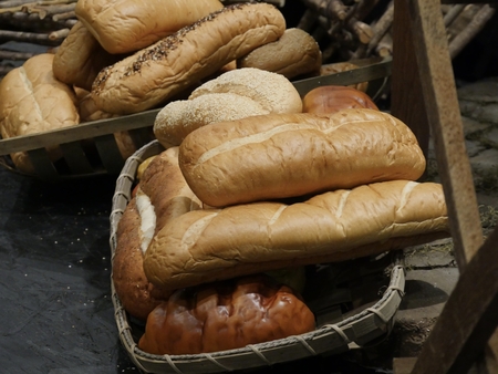 Loaves of assorted bread arrange in wicker baskets